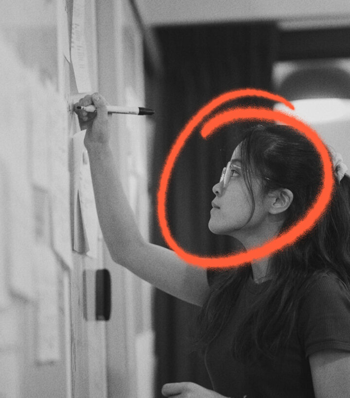 Woman writing on whiteboard